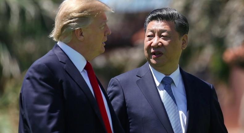 U.S. President Donald Trump and China's President Xi Jinping chat as they walk along the front patio of the Mar-a-Lago estate after a bilateral meeting in Palm Beach, Florida, U.S., April 7, 2017.