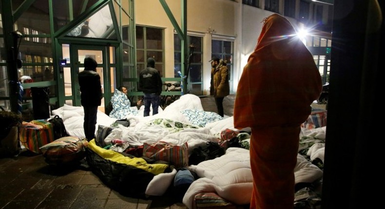 Refugees sleep outside the entrance of the Swedish Migration Agency's arrival center for asylum seekers at Jagersro in Malmo, Sweden, in November 2015