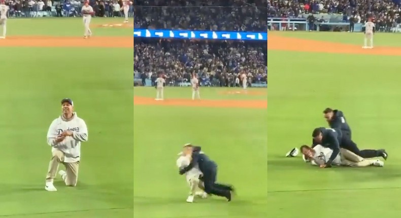 A Dodgers fan is tackled by security mid-proposal.@EmSheDoesIt / Twitter