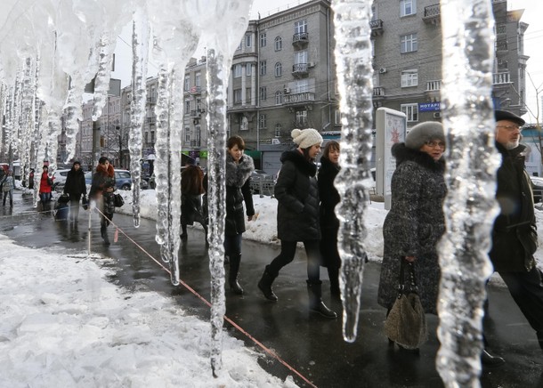 People walk past icicles in central Kiev