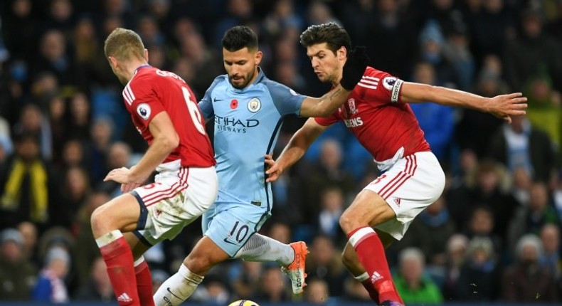 Manchester City's Sergio Aguero (C) tries to find a gap between Middlesbrough's Ben Gibson (L) and George Friend