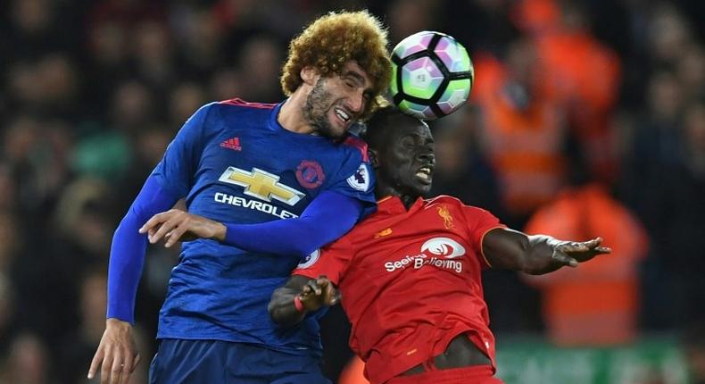 Manchester United's Marouane Fellaini (left) battles with Liverpool's Sadio Mane at Anfield on October 17, 2016