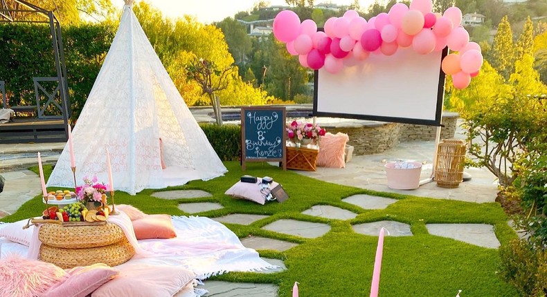 A backyard movie experience complete with a balloon garland, movie theatre concessions, and a fun night under the stars.
