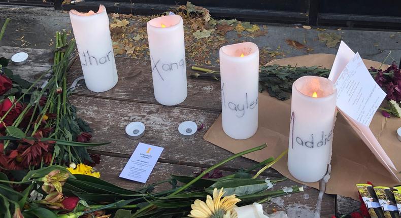 Candles and flowers are left at a make-shift memorial honoring four slain University of Idaho students outside the Mad Greek restaurant in downtown Moscow, Idaho, on Tuesday, Nov. 15, 2022.Nicholas K. Geranios/AP Photo