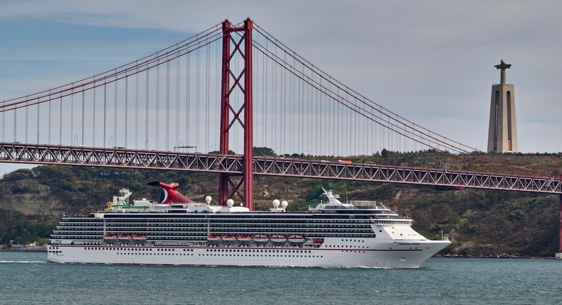 Carnival Pride, a Spirit-class cruise ship operated by Carnival Cruise Line, sails across the Tagus River.