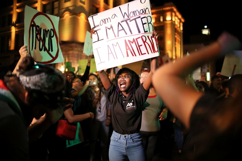 A female protester holds a sign during an anti-Trump march in downtown San Diego, California.