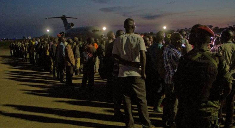 Members of the M23 rebel group waiting at a Ugandan army air base to be flown to the Democratic Republic of Congo in 2014