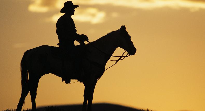 Silhouette of cowboy on horseback.Comstock via Getty Images.