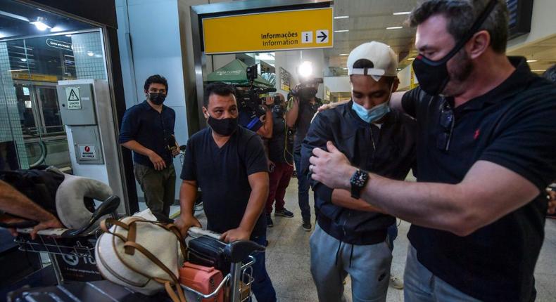 Brazilian footballer Pedrinho (second right) is hugged upon his arrival back in Brazil from Ukraine where he plays for Shakhtar Donetsk Creator: NELSON ALMEIDA