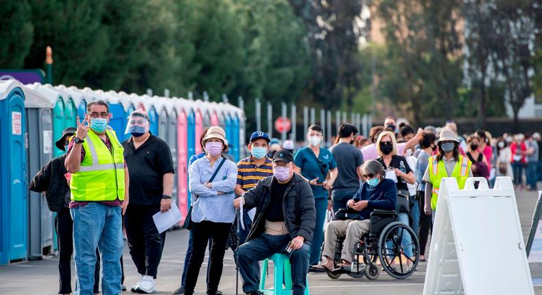 People wait in line in a Disneyland parking lot to receive Covid-19 vaccines on the opening day of the Disneyland Covid-19 vaccination site in Anaheim, California.Valerie Macon/AFP/Getty Images