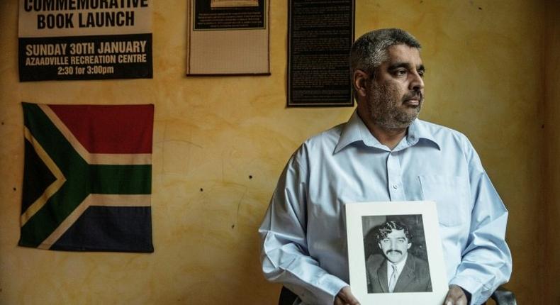 Imtiaz Cajee, the nephew of Ahmed Timol, an anti-apartheid activist brutally murdered in police custody in October 1971, holds a portrait of his uncle at his house in Pretoria