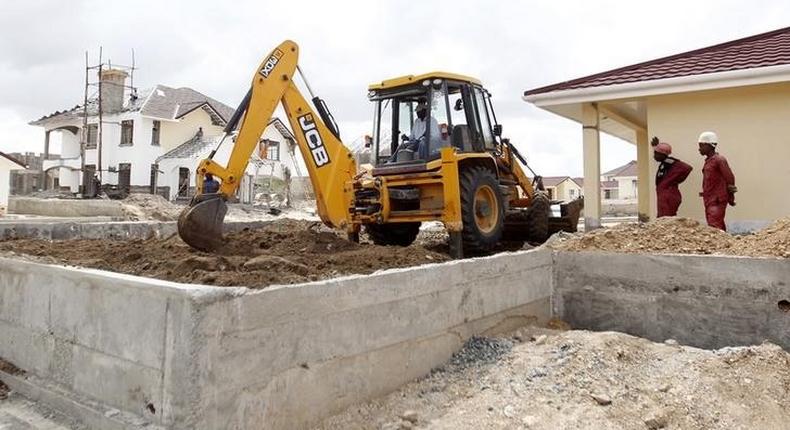 A worker uses heavy machinery to level the ground at the construction site within the Greenpark estate in Lukenya, near Kenya's capital Nairobi, October 31, 2014.  REUTERS/Thomas Mukoya