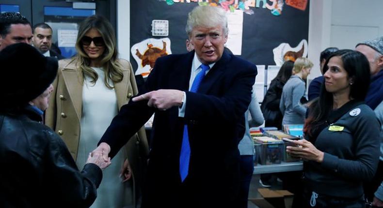 Republican presidential nominee Donald Trump shakes hands with a woman before voting at PS 59 in New York, New York, U.S. November 8, 2016