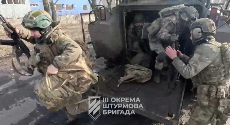 Ukrainian soldiers get out of a military vehicle in a location given as Avdiivka, Donetsk Region, Ukraine, in this screen grab taken from a video released Feb. 17, 2024.3rd Assault Brigade/Handout via REUTERS