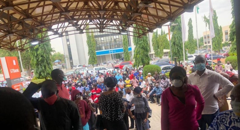 Customers crowd a bank entrance in Lagos on May 4, 2020 