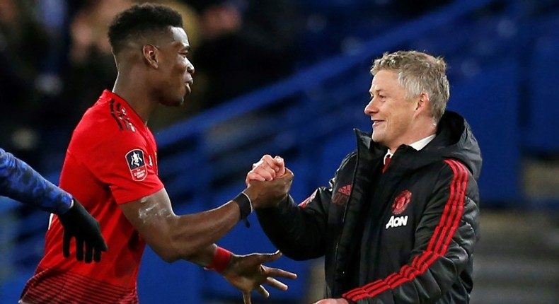 Manchester United manager Ole Gunnar Solskjaer celebrates with Paul Pogba