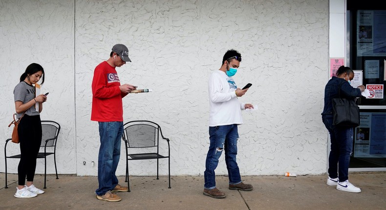 FILE PHOTO: People who lost their jobs wait in line to file for unemployment following an outbreak of the coronavirus disease (COVID-19), at an Arkansas Workforce Center in Fayetteville, Arkansas, U.S. April 6, 2020. REUTERS/Nick Oxford