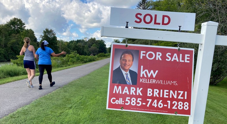 People walk by a sold sign in front of a house along the Erie Canal in Pittsford, New York, on Monday, Sept. 6, 2021.Ted Shaffrey/AP Photo