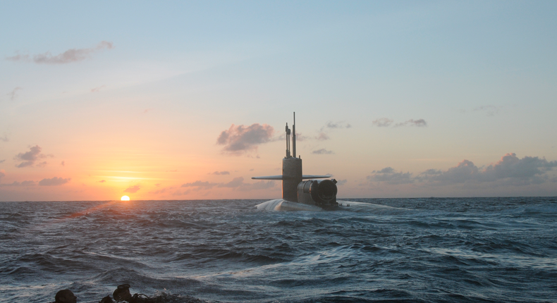 SEALs and divers from SEAL Delivery Vehicle Team 1 swimming back to the guided-missile submarine USS Michigan during an exercise.