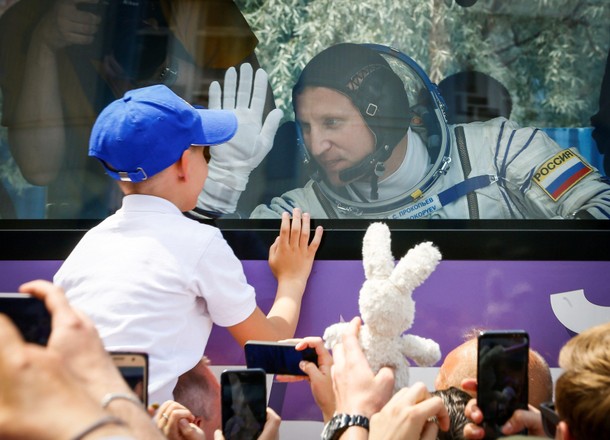 International Space Station (ISS) crew member Sergey Prokopyev of Russia waves to his family from a 