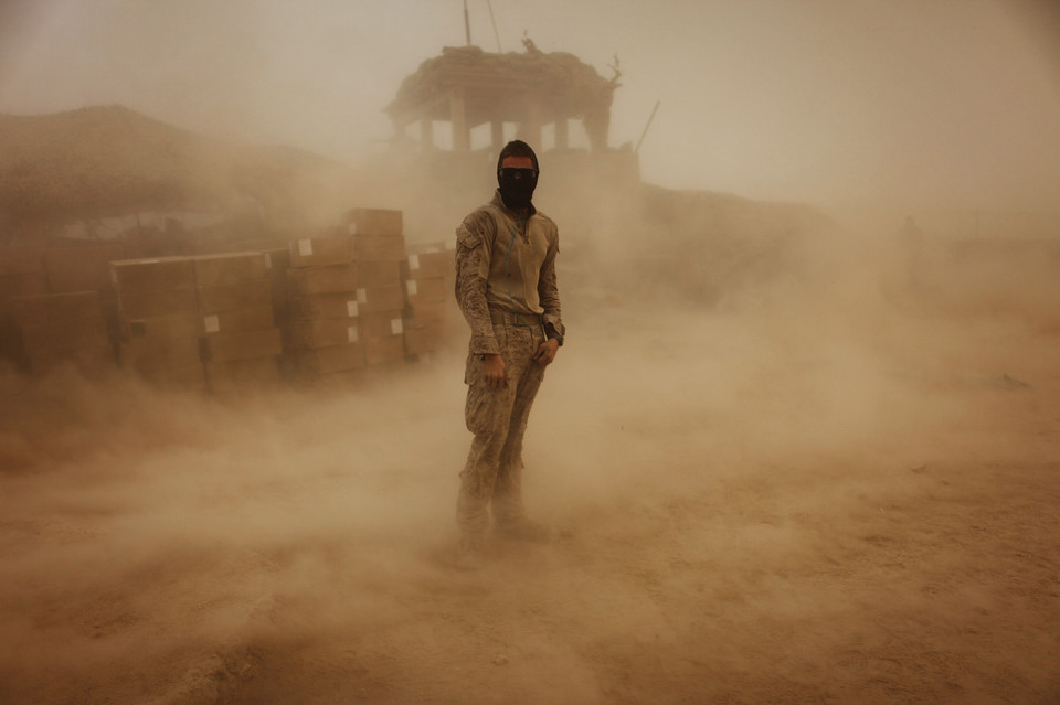 Private First Class Brandon Voris, 19, of Lebanon, Ohio, from the First Battalion Eighth Marines Alpha Company sta ds in the middle of his camp as a sandstorm hits his remote outpost near Kunjak in southern Afghanistan's Helmand province, October 28, 2010