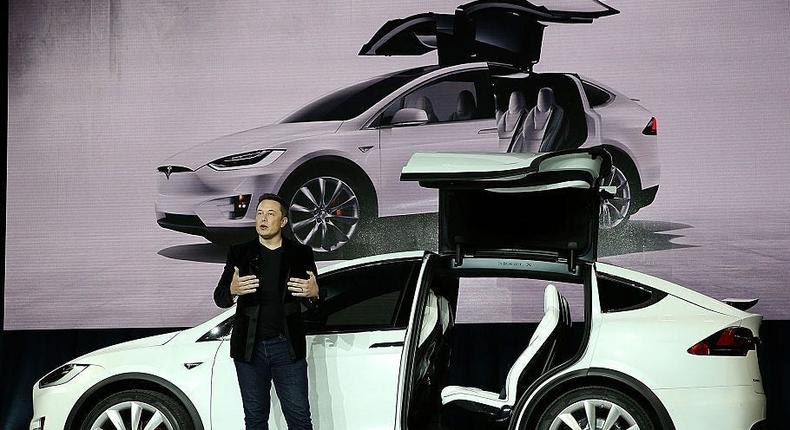 Elon Musk in front of a TeslaGetty