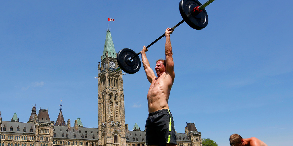 A man lifts weights on Parliament Hill in Ottawa May 30, 2013.