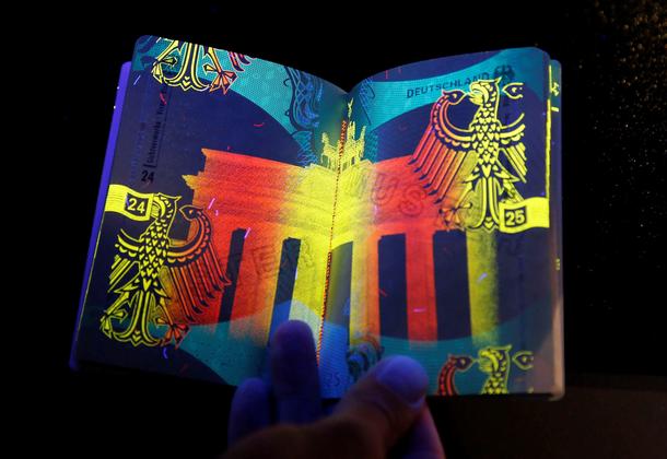 The new German electronic passport is pictured under an ultraviolet light during its presentation to