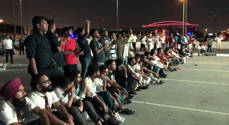 Indian fans who could not get tickets watch on a giant screen outside the stadium where Qatar play India in a World Cup tie