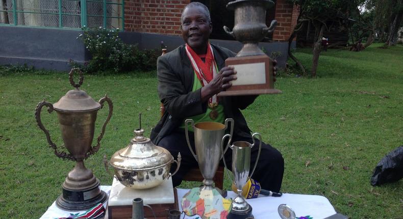 Athletics legend Benjamin Jipcho Chemaima showcasing some of his awards during a past media interview