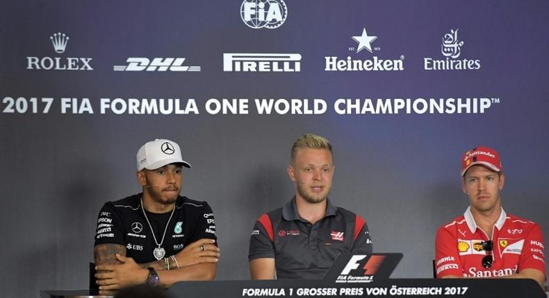 (From L) Mercedes' British driver Lewis Hamilton, Haas F1's Danish driver Kevin Magnussen and Ferrari's German driver Sebastian Vettel attend a driver's press conference ahead of the Austrian Formula One Grand Prix in Spielberg on July 6, 2017.