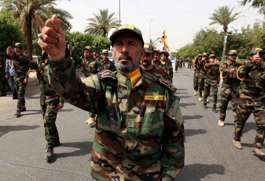 Pripadnici iračke šiitske milicije Al Džihad brigade na paradi u Bagdadu 8. juna 2018.