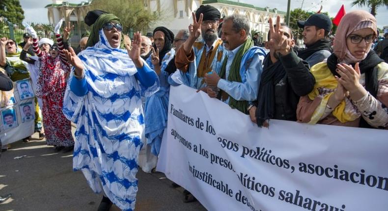 Supporters of the Western Sahara's Polisario Front shout slogans during a demonstration outside the court in Sale on March 13, 2017