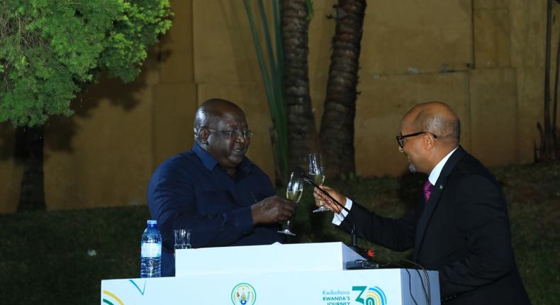 Minister Okello Oryem toasts with Rwanda’s High Commissioner to Uganda, Joseph Rutabana.