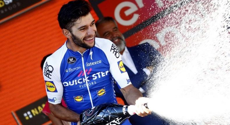 Colombian Fernando Gaviria, of the Quick Step team, celebrates on the podium after winning the 13th stage of the 100th Giro d'Italia, Tour of Italy cycling race, from Reggio Emilia to Tortona on May 19, 2017