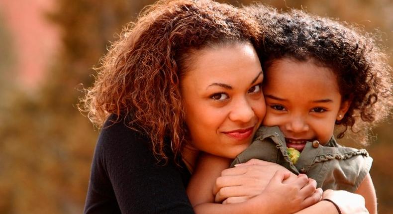 Mother hugging daughter