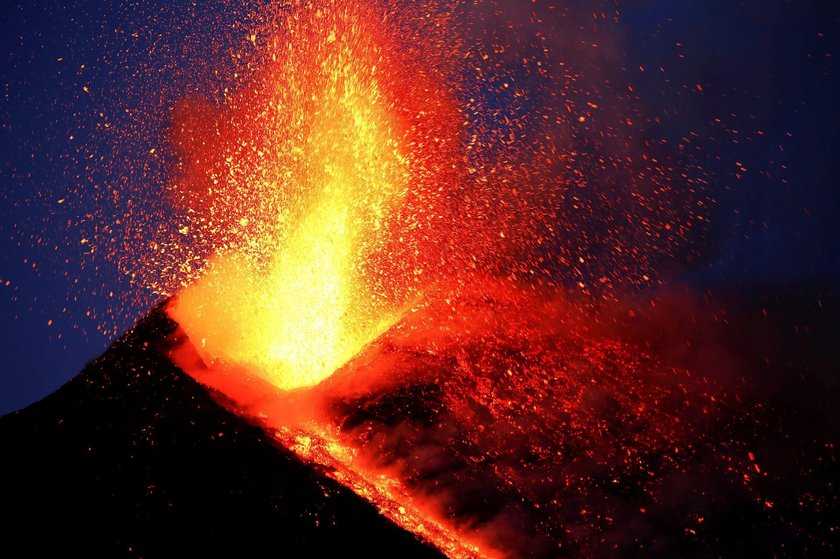 FILE PHOTO: Italy's Mount Etna, Europe's tallest and most active volcano, spews lava as it erupts on