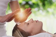 Woman having reiki healing treatment , alternative medicine concept.