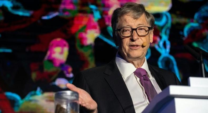 Microsoft founder Bill Gates talks next to a container with human feces, a stunt to draw attention to the lack of toilets in developing countries around the world