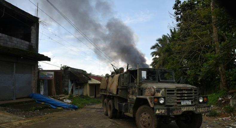 The militants, initially estimated to number just 100, have withstood eight days of intense air assaults and street-to-street combat, prompting the Philippine government to call on them to surrender