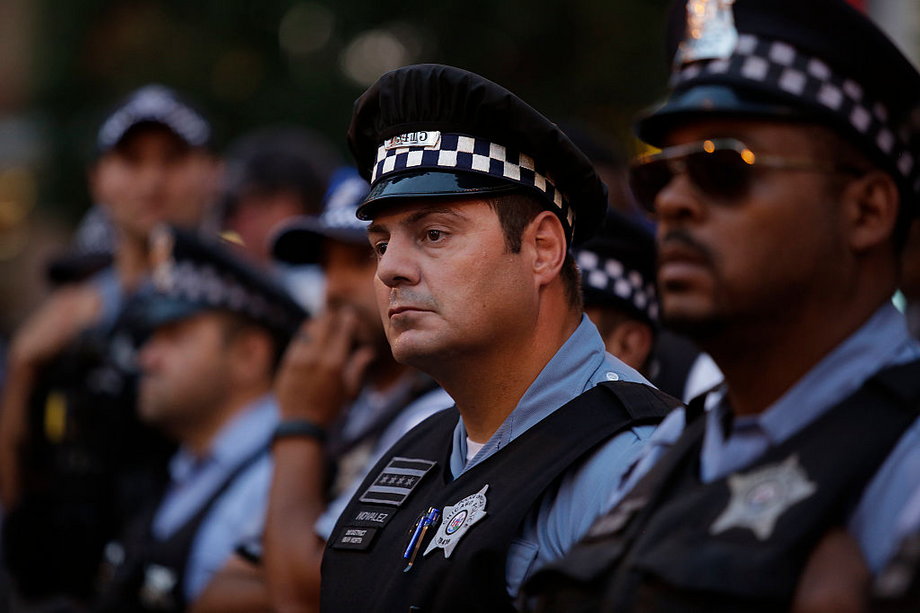 Police officers watching as demonstrators protested the fatal police shooting of Paul O'Neal on August 7 in Chicago.