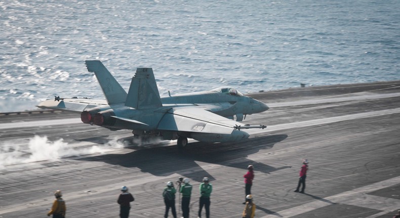 Sailors observe an F/A-18E Super Hornet launch from the flight deck of the aircraft carrier USS Dwight D. Eisenhower in the Red Sea in April 2024.US Navy photo