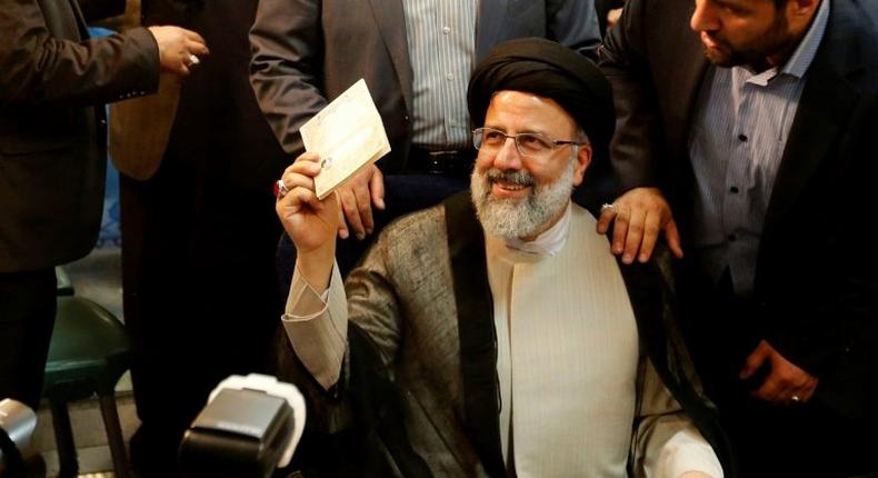 Iranian cleric Ebrahim Raisi gestures after registering his candidacy for the upcoming presidential elections at the ministry of the interior in Tehran on April 14, 2017