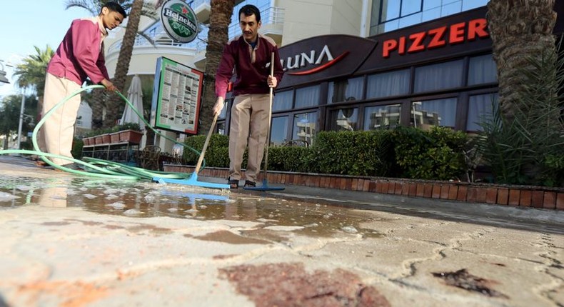 Cleaners try to clean blood stains near the entrance to Bella Vista Hotel in the Red Sea resort of Hurghada, Egypt, January 9, 2016. Two armed assailants attacked a hotel in the Egyptian Red Sea resort town of Hurghada on Friday, wounding three foreign tourists, Egyptian officials said. REUTERS/Mohamed Abd El Ghany