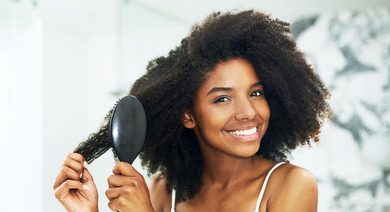 230305-1455x1098-young woman brushing her hair