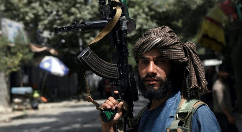 A Taliban fighter stands guard at a checkpoint in Kabul, Afghanistan.