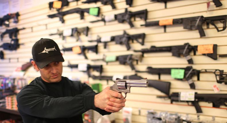 An employee at a gun store in Delray Beach, Florida, gives a demonstration in January 2016.