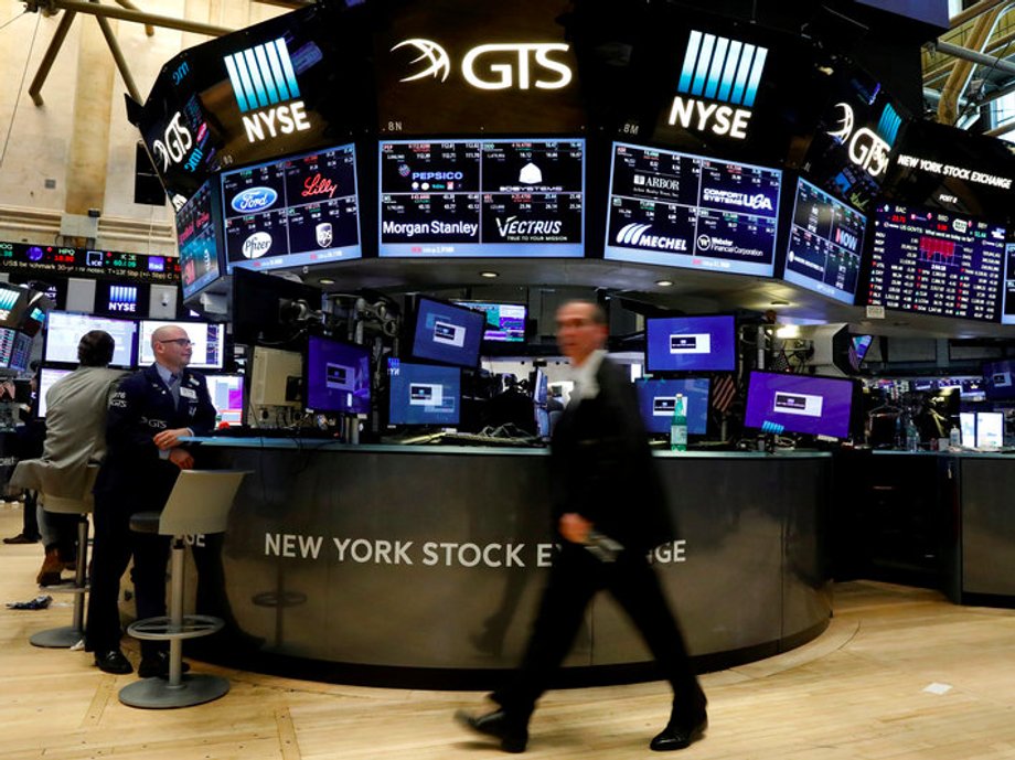 Traders work on the floor of the NYSE in New York