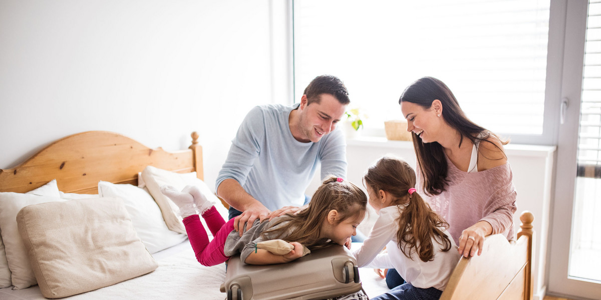 Young family with two children packing for holiday.