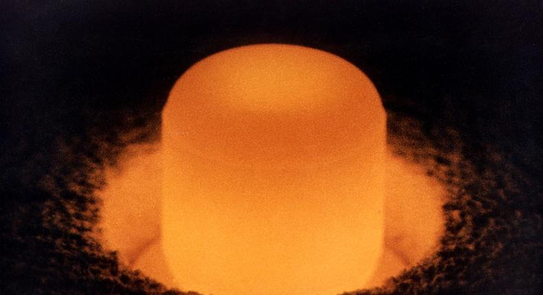 A pellet of plutonium-238 dioxide glows under its own warmth.